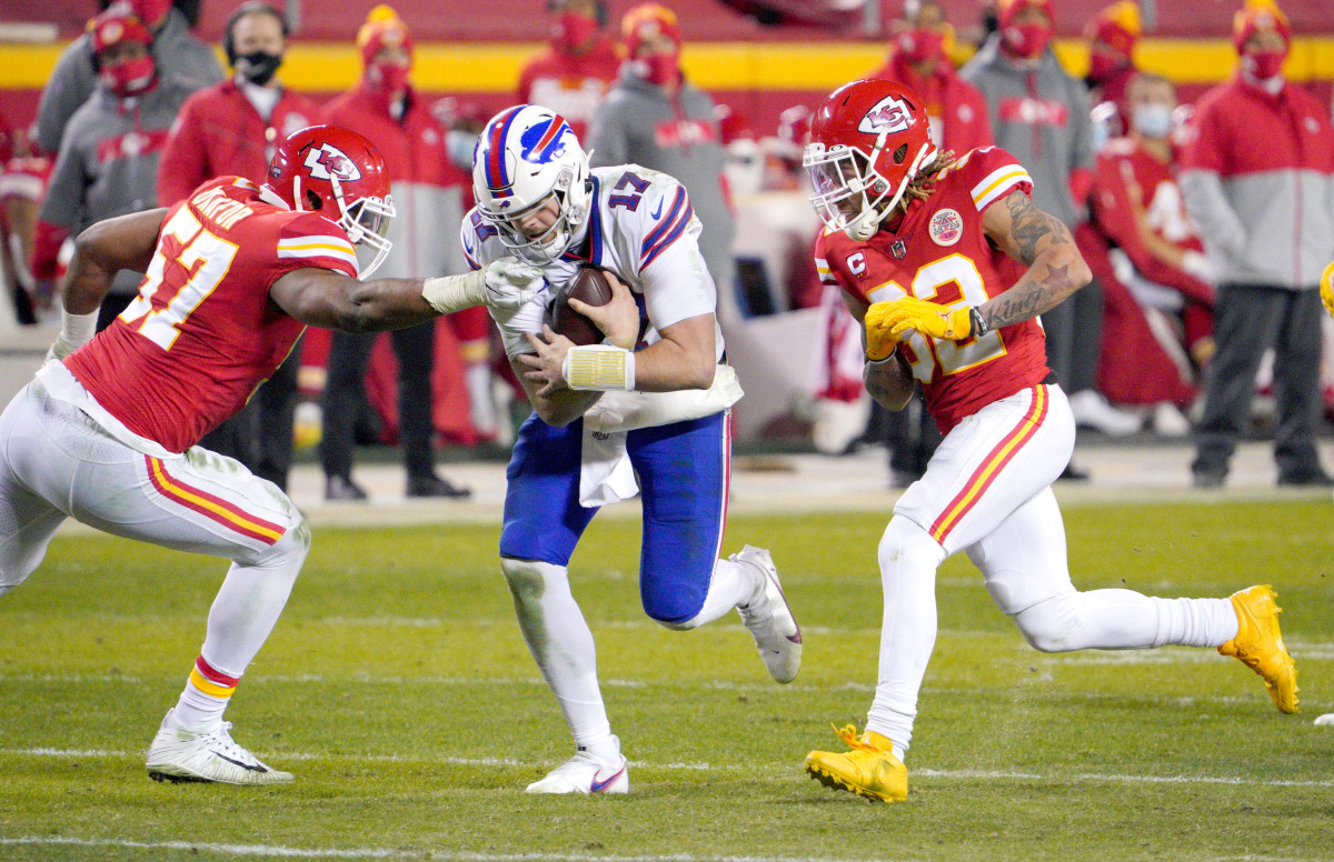 Jan 24, 2021; Kansas City, Missouri, USA; Buffalo Bills quarterback Josh Allen (17) scrambles as Kansas City Chiefs defensive end Alex Okafor (57) and strong safety Tyrann Mathieu (32) attempt the sack in the AFC Championship Game at Arrowhead Stadium. 